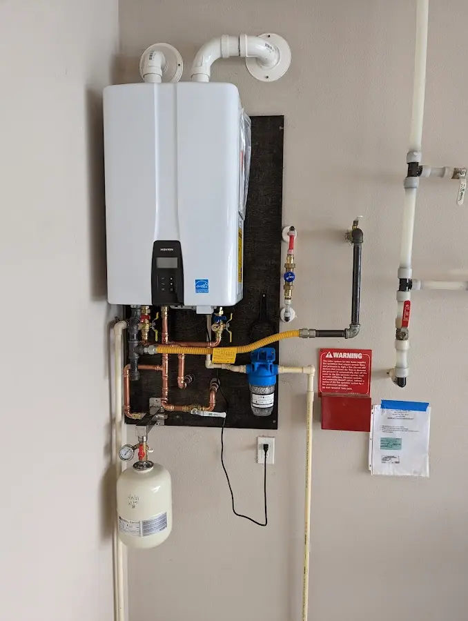 Professional plumber installing copper piping in a Watertown home
